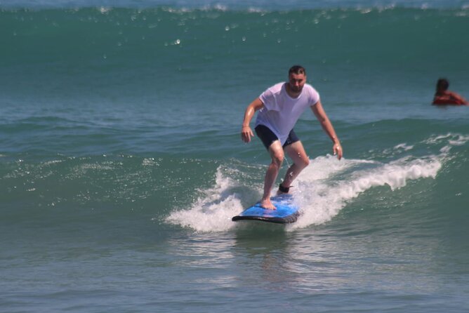 Private Beginner 1 on 1 Surf Lesson at Kuta Beach - Getting ready with a board, rashguard, and zinc